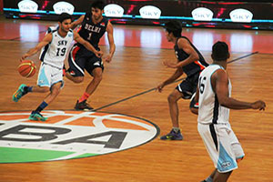 Hyderabad Skys Himanshu Jhangda tries to get out of a halfcourt trap set by Delhi Capitals