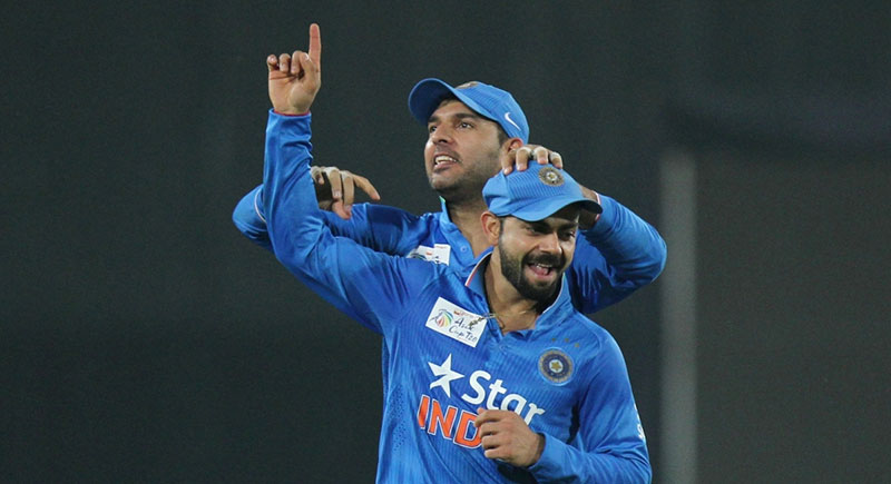 Indian players Virat Kohli and Yuvraj Singh celebrate fall of a wicket