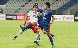 Bengaluru FC skipper Sunil Chhetri controls a high ball as an Aizawl FC player attempts to thwart the danger