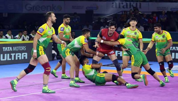 Defending champion teams captain Rohit Kumar makes his raid through the tough grip of Patna Pirates Defending champion teams captain Rohit Kumar makes his raid through the tough grip of Patna Pirates