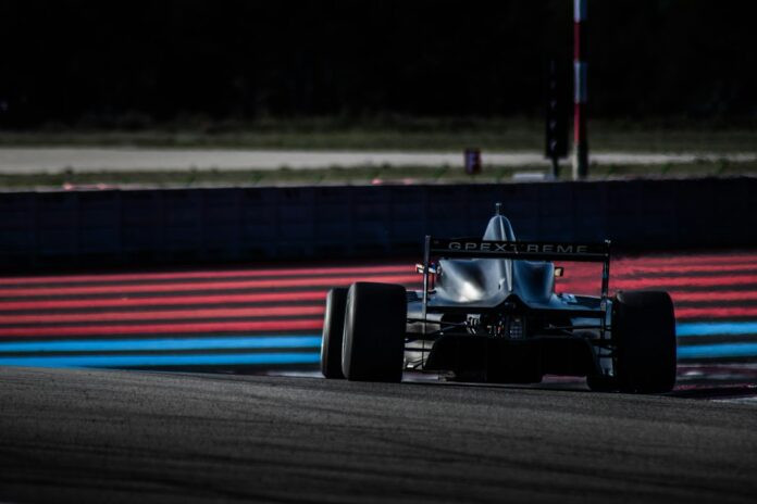 A junior single-seater racing car on a circuit, representing F1 Academy racing
