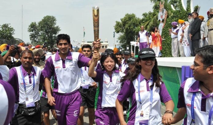 Boxer Vijender Singh, with Mary Kom, carrying the Queen's Baton for the Delhi 2010 Commonwealth Games at the Wagah border